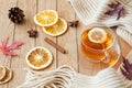 CupÃÂ ofÃÂ teaÃÂ withÃÂ lemonÃÂ onÃÂ aÃÂ woodenÃÂ tableÃÂ withÃÂ aÃÂ knittedÃÂ scarfÃÂ andÃÂ decorations